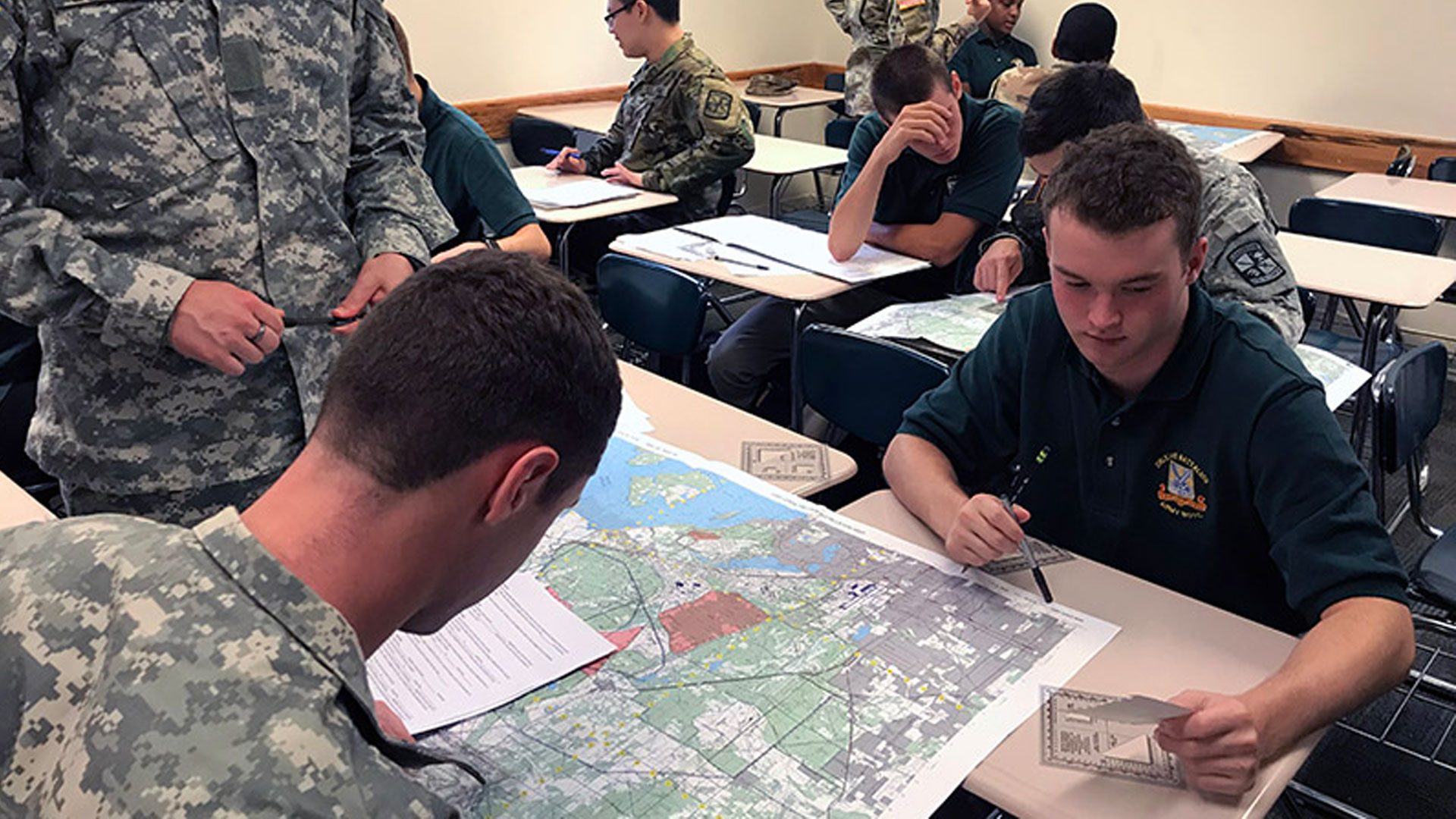 Cadets examine map during class